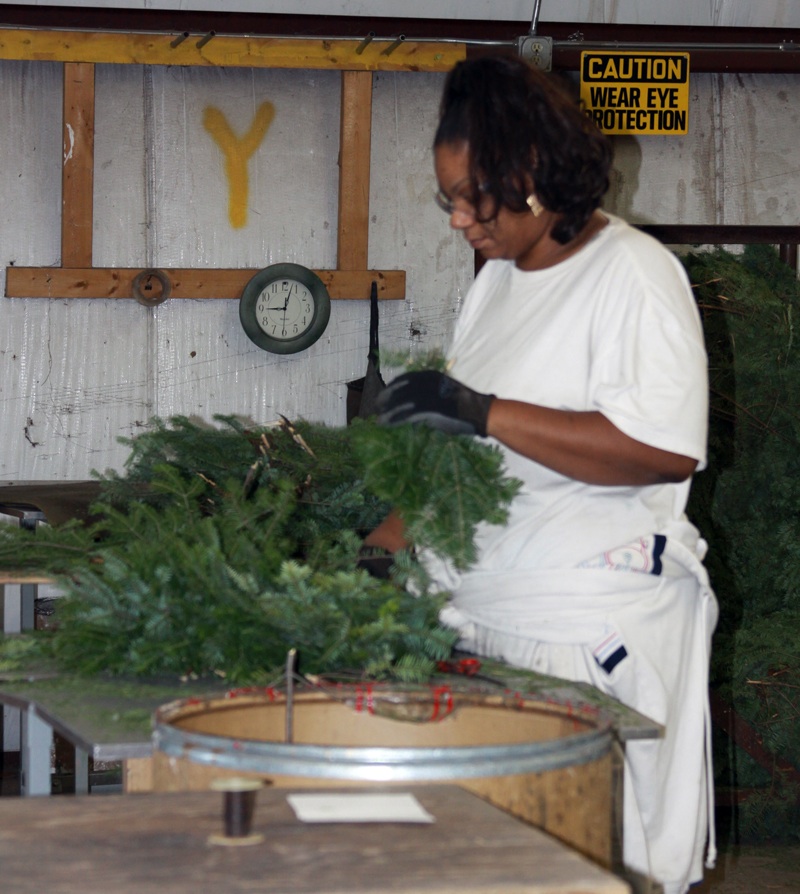 One of 90 employees busy hand crafting wreaths at Winter Woods in Glidden, Wisconsin.